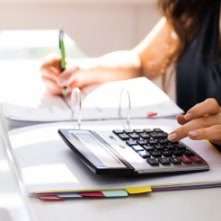 Woman using a calculator and studying